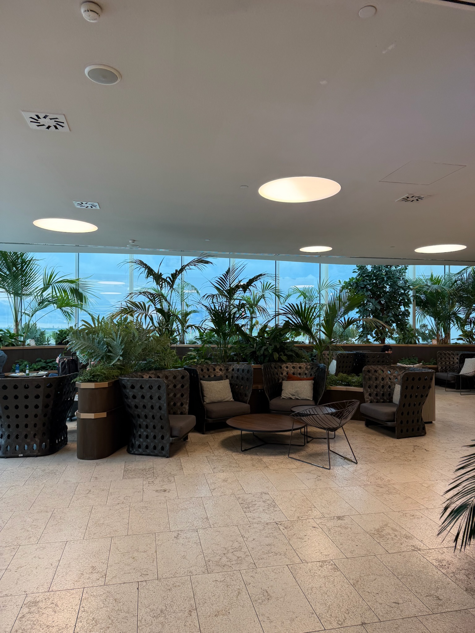 Marco Polo Club Lounge Venice Airport seating area with several tropical plants